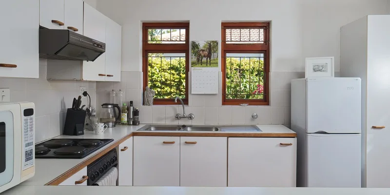 A bright white kitchen with a lowered counter section, open knee space beneath the sink and deep pull out drawers.