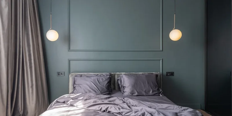 A bed rail clamped to the frame of an adjustable bed with the head section slightly raised.