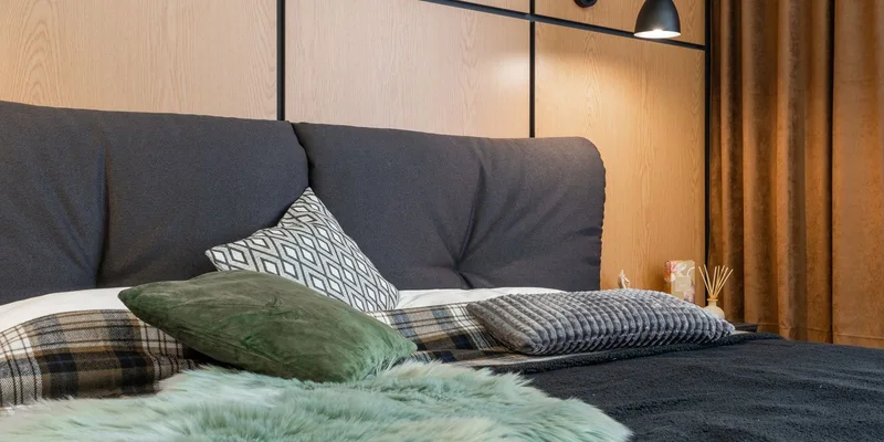 A bedroom arranged for safe movement with a knee height bed, a lit path to the door and clear floor.