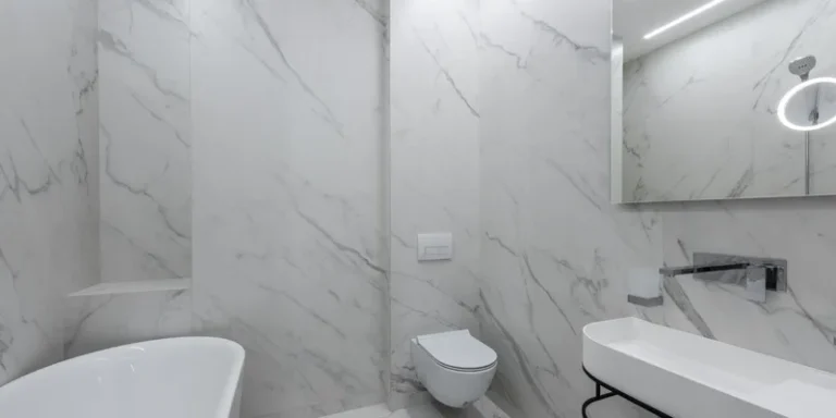 A white raised toilet seat clamped onto a toilet bowl in a clean bright bathroom.