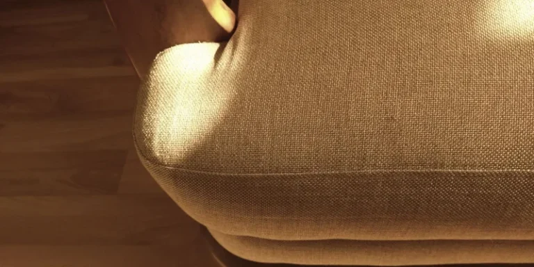 Sturdy furniture risers lifting the legs of an armchair on a living room rug.