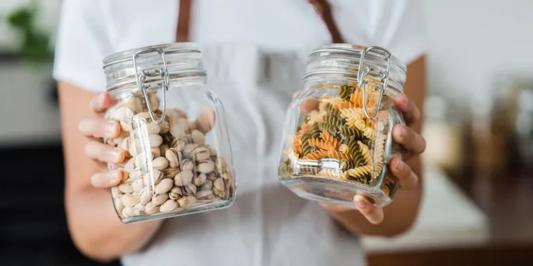 An under cabinet jar opener and a rubber grip pad on a kitchen counter beside a closed jar.