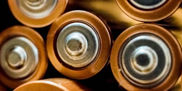 Close-up of the ends of several cylindrical battery cells.