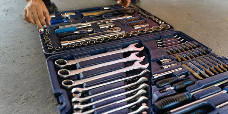 An open toolbox with a set of wrenches and sockets.