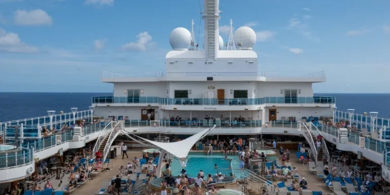 Passengers on the open deck of a cruise ship.