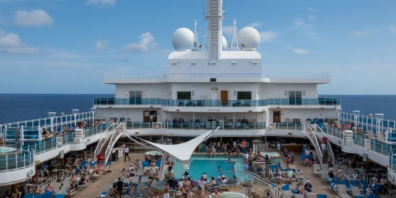 Passengers on the open deck of a cruise ship.