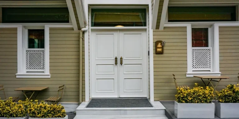 A rubber threshold ramp fitted at a front door with the door standing open.