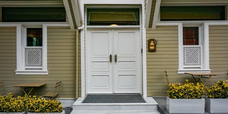 A rubber threshold ramp fitted at a front door with the door standing open.