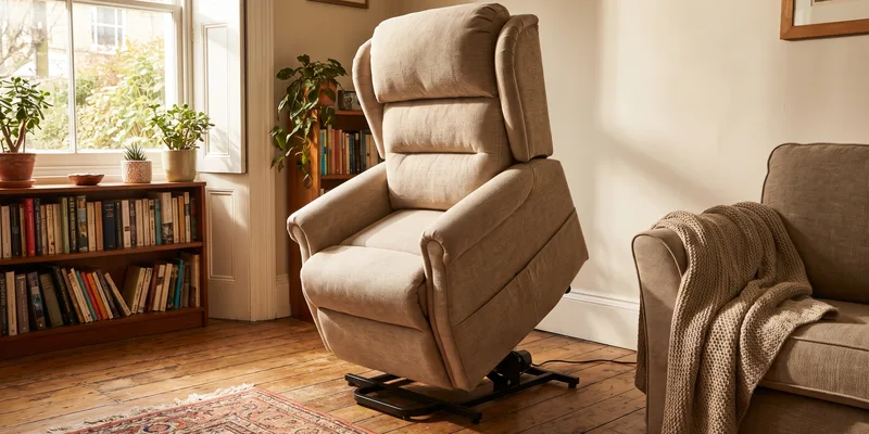 A power lift recliner in the raised position in a modest living room.